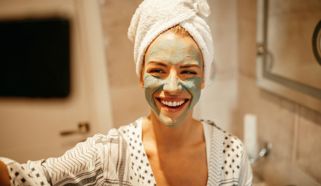 beautiful women taking pictures with face masks