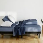 adjustable bed with pillows and blanket