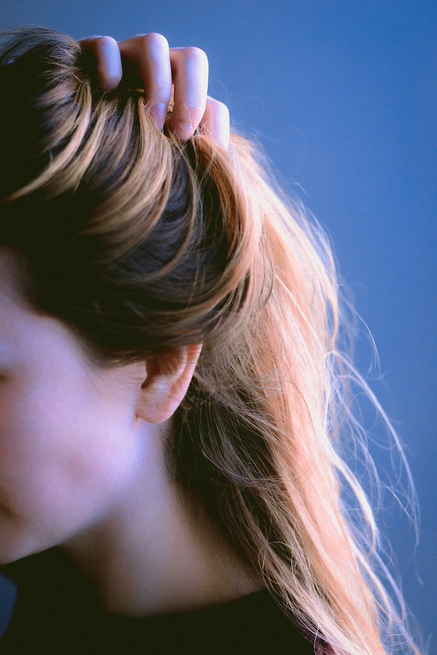 picture of a woman holding her hair 