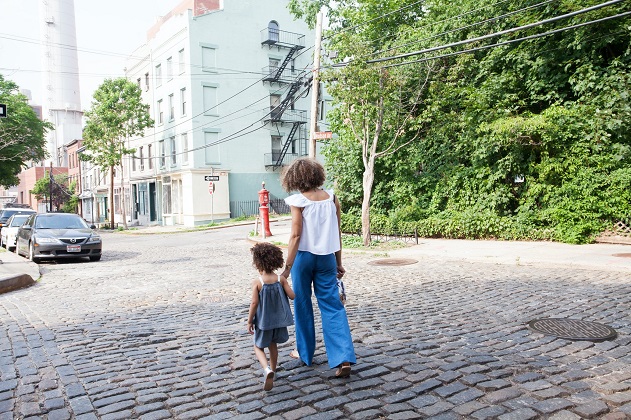 picture of woman and a baby girl walking on the street