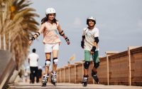 picture of a girl and a boy driving a rollerblades outside