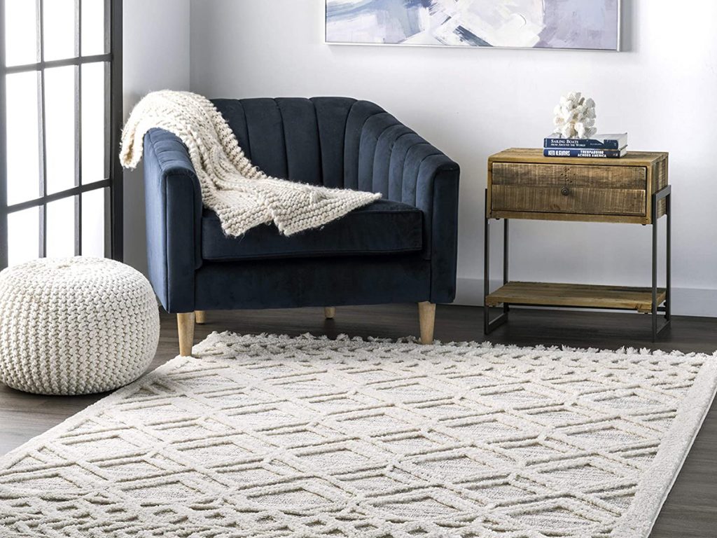 Rugs have the power to anchor the whole space together. It can set the tone for the entire room and create a neatly layered room. Even though it may look like a difficult decision, if you know what you’re looking for in terms of material, colour and size, the choice will be easy. If you opt for a large rug, it should cover a more significant part of the floor and keep some of the furniture on it. A small one should sit independently. If you have hardwood floors, it’s best to get a larger one so the legs of the crib and closet can overlap on the rug. People usually buy smaller rugs to highlight a particular area or a piece of furniture such as a crib.