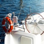 boat sails with lifebuoy ring on the front