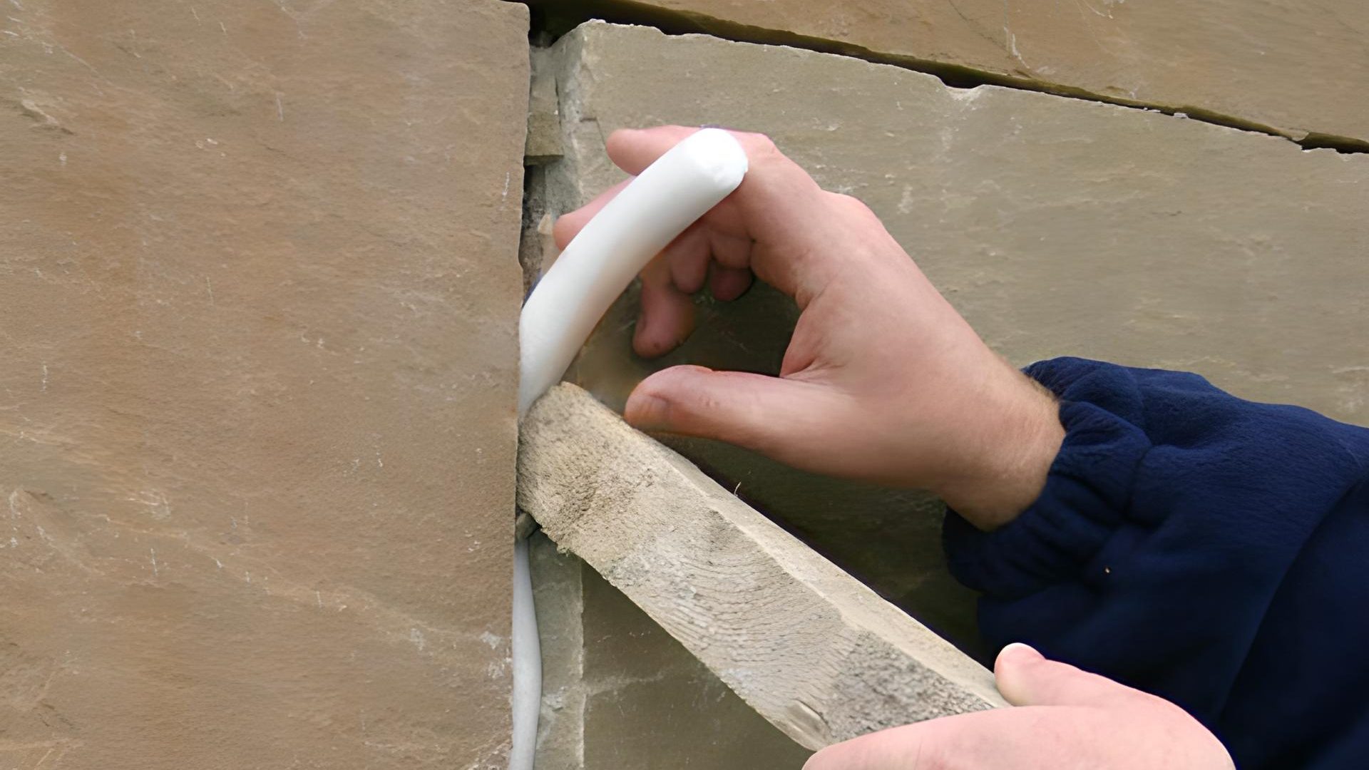 installing backing rod in between stones