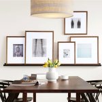 large photo frames hung on wall in a dining room