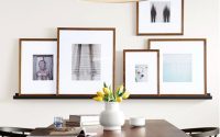 large photo frames hung on wall in a dining room