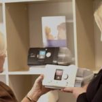 two women holding cpap machine