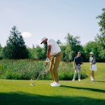 people playing golf on the course